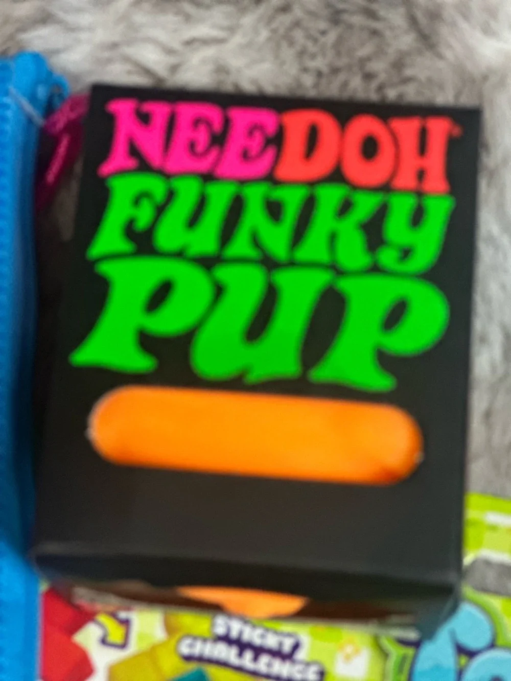 A Bundle of Squeezable’s with one orange NEE DOH FUNKY PUP. New